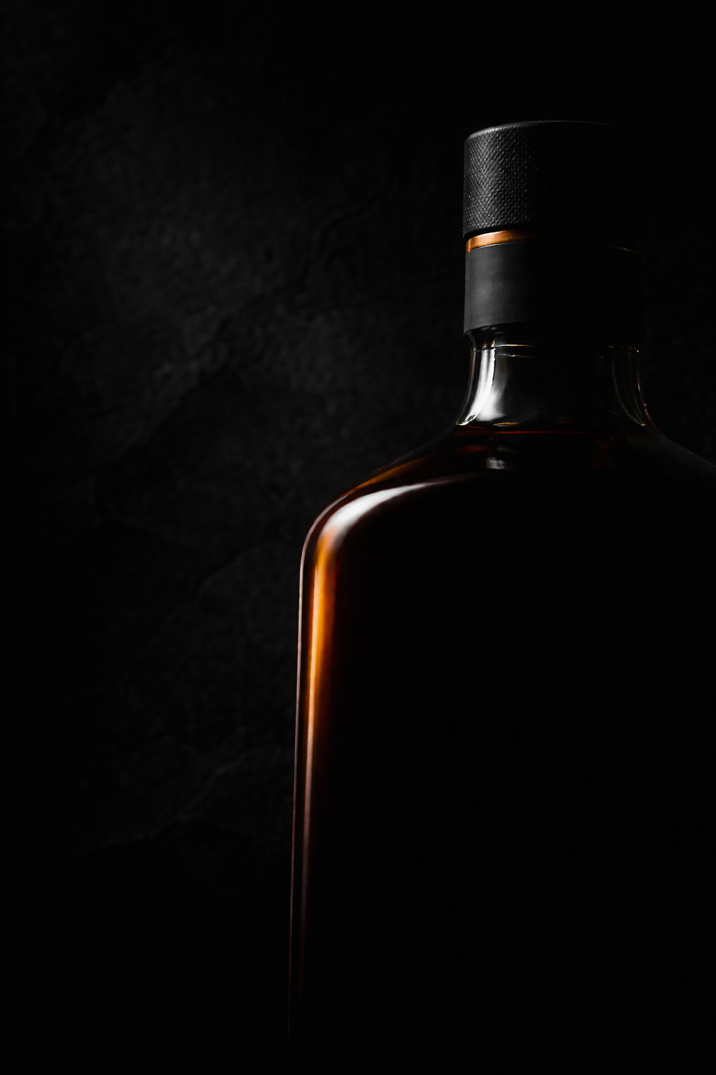 Dark bottle silhouette in cinematic lighting